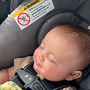 Nashtyn joined the competition — help win amazing prizes! baby, blanket, car_seat, child, close_up, clothing, comfort, cozy, face, head, indoor, infant, peaceful, resting, safety, seat_belt, sleeping, soft_light, warning_label, young_child