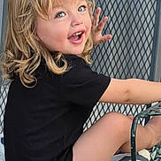 Oziah is registered to the contest to win money with this photo: black_shirt, blonde_hair, casual_clothing, chair, child, curly_hair, cushion, cute, expression, face, happy, metal_chair, outdoor, pattern, playful, portrait, seated, smiling, toddler, young