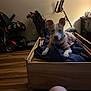 dog, pet, indoor, wooden_bed, blanket, furniture, floor, human_leg, exercise_equipment, chair, wall, lighting, room, clothing, dog_outfit, ears, flooring, relaxation, domestic, cozy