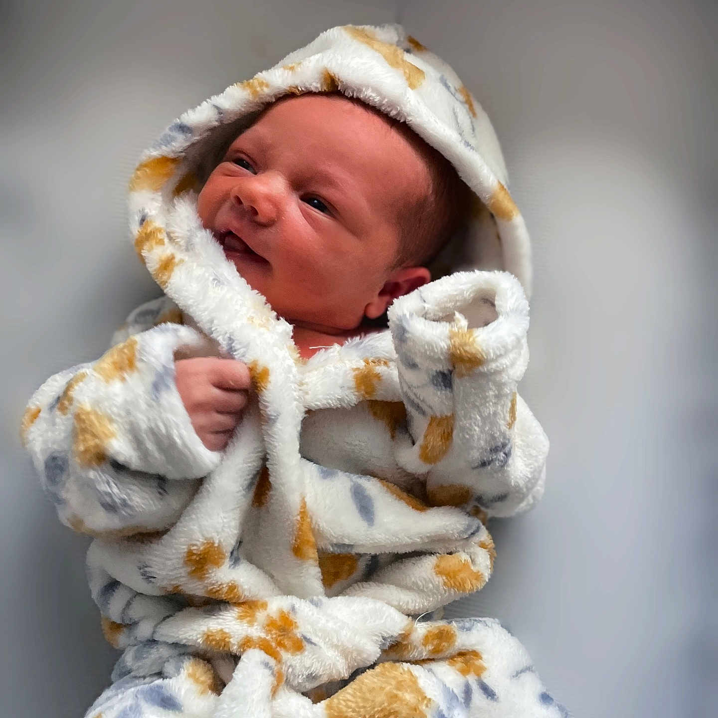 Olivia joined the competition — help win amazing prizes! baby, blanket, bodypart, clothing, face, finger, hand, happy, hat, head, hood, hoodie, knitwear, newborn, person, photography, portrait, smile, sweater, towel