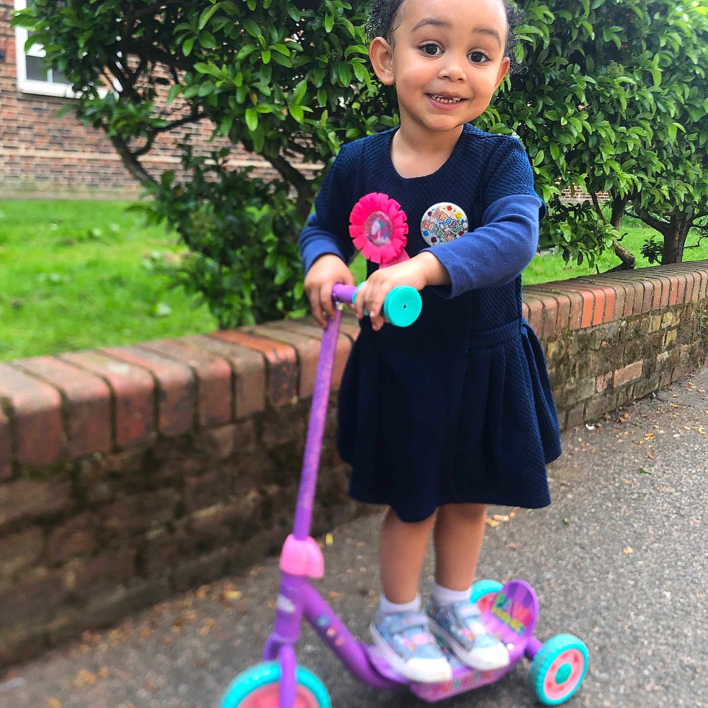 Krystal is registered to the contest to win money with this photo: birthday_badge, blue_dress, brick_wall, celebration, child, daytime, fun, girl, greenery, happy, nature, outdoor, person, playful, scooter, shoes, sidewalk, smiling, tiara, young_child