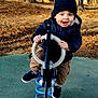 Tommy participe au concours pour gagner de l'argent avec cette photo : active, autumn, beanie, blue_eyes, casual_clothing, child, daylight, fall_leaves, fun, happy, jacket, outdoor, park, play, playground, smiling, sneakers, spring_rocker, toddler, trees