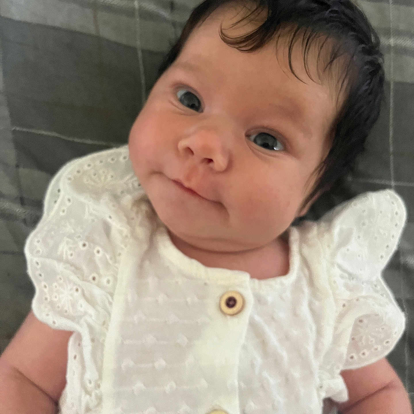 Aurora-Mai is registered to the contest to win money with this photo: baby, button, child, close_up, cute, expression, eyes, fabric, face, hair, indoors, infant, lying_down, newborn, person, portrait, skin, small_hands, soft_texture, white_clothing