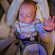 Dawson is registered to the contest to win money with this photo: baby, sleeping, car_seat, onesie, tom_and_jerry, hand, pacifier, blanket, infant, child, cozy, cute, resting, indoors, soft_lighting, seatbelt, fabric, head_support, peaceful, young