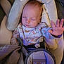 baby, sleeping, car_seat, onesie, tom_and_jerry, hand, pacifier, blanket, infant, child, cozy, cute, resting, indoors, soft_lighting, seatbelt, fabric, head_support, peaceful, young