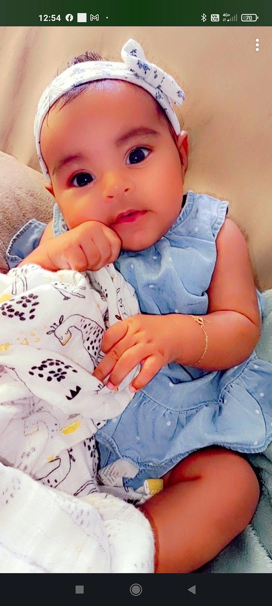 Léanah participe au concours pour gagner de l'argent avec cette photo : baby, baby_toddler_clothing, blue, cap, cheek, child, comfort, finger, happy, iris, lip, nail, person, pink, product, skin, sleeve, textile, toddler, white