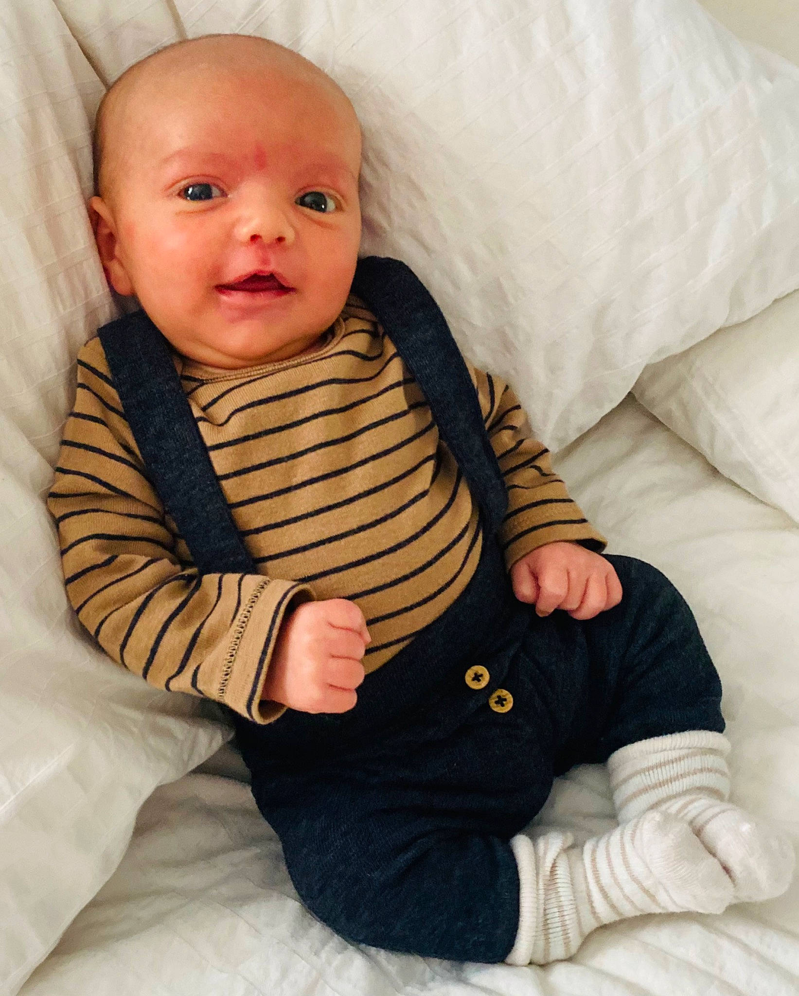 Lucas Broadbent is registered to the contest to win money with this photo: arm, baby, baby_sleeping, baby_toddler_clothing, cheek, child, comfort, fur, gesture, happy, linens, nose, person, product, room, sitting, skin, sleeve, smile, thumb