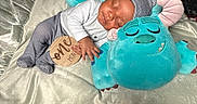 Akylo is registered to the contest to win money with this photo: baby, sleeping, infant, plush_toy, blue_monster, striped_pajamas, hat, blanket, wooden_sign, one_month, cuddling, cute, soft_toy, newborn, peaceful, indoors, child, portrait, milestone, resting
