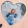 baby, infant, blue_onesie, panda_print, soft_blanket, heart_cutout, wooden_sign, two_months, pacifier, lying_down, smiling, cute, child, portrait, indoors, cozy, newborn, sleepsuit, baby_brother, baby_clothing