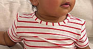 Aliana is registered to the contest to win money with this photo: toddler, child, dress, striped_clothing, sitting, couch, indoors, curly_hair, earring, cute, portrait, baby, young_child, comfortable, soft_furniture, looking_away, innocent, happy, small_shoes, casual