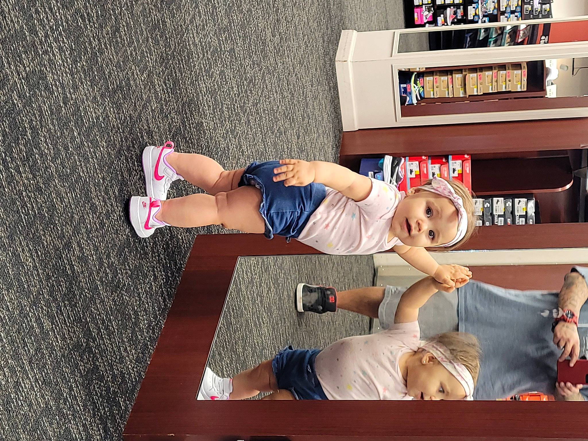 Sascha Elizabeth Lynne joined the competition — help win amazing prizes! arm, bookcase, child, comfort, fun, hat, headwear, human_leg, knee, leisure, person, sandal, shelf, shelving, shorts, sitting, smile, t_shirt, thigh, toddler