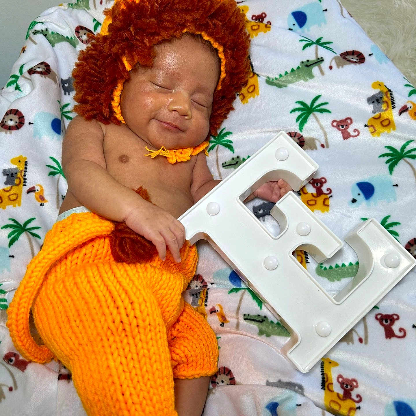 Ethan is registered to the contest to win money with this photo: accessories, baby, bed, bedroom, blanket, cushion, face, furniture, hair, happy, head, homedecor, indoors, jewelry, necklace, person, photography, portrait, room, smile