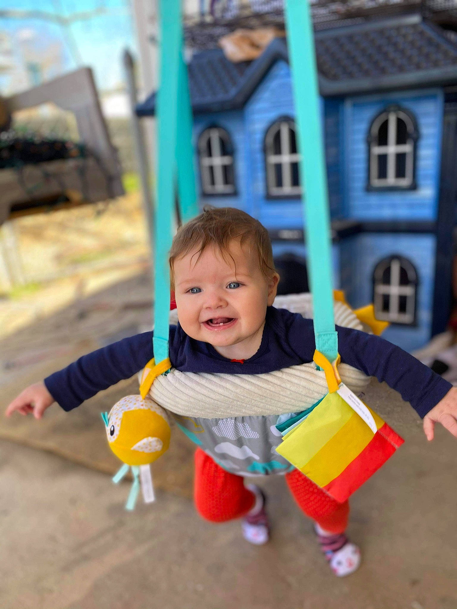 Elena is registered to the contest to win money with this photo: baby, baby_toddler_clothing, child, city, fun, grass, happy, leisure, orange, outdoor_play_equipment, people, person, public_space, recreation, smile, swing, t_shirt, toddler, window, wood