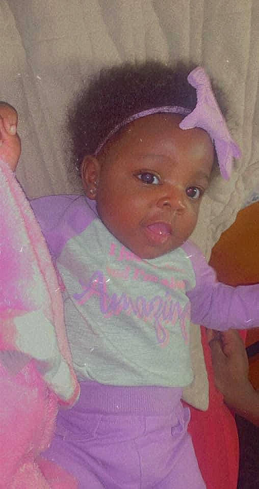 Nevaeh joined the competition — help win amazing prizes! baby, cheek, chin, ear, eye, eyebrow, facial_expression, forehead, hair, hairstyle, human, iris, lip, mouth, nose, person, product, purple, skin, standing