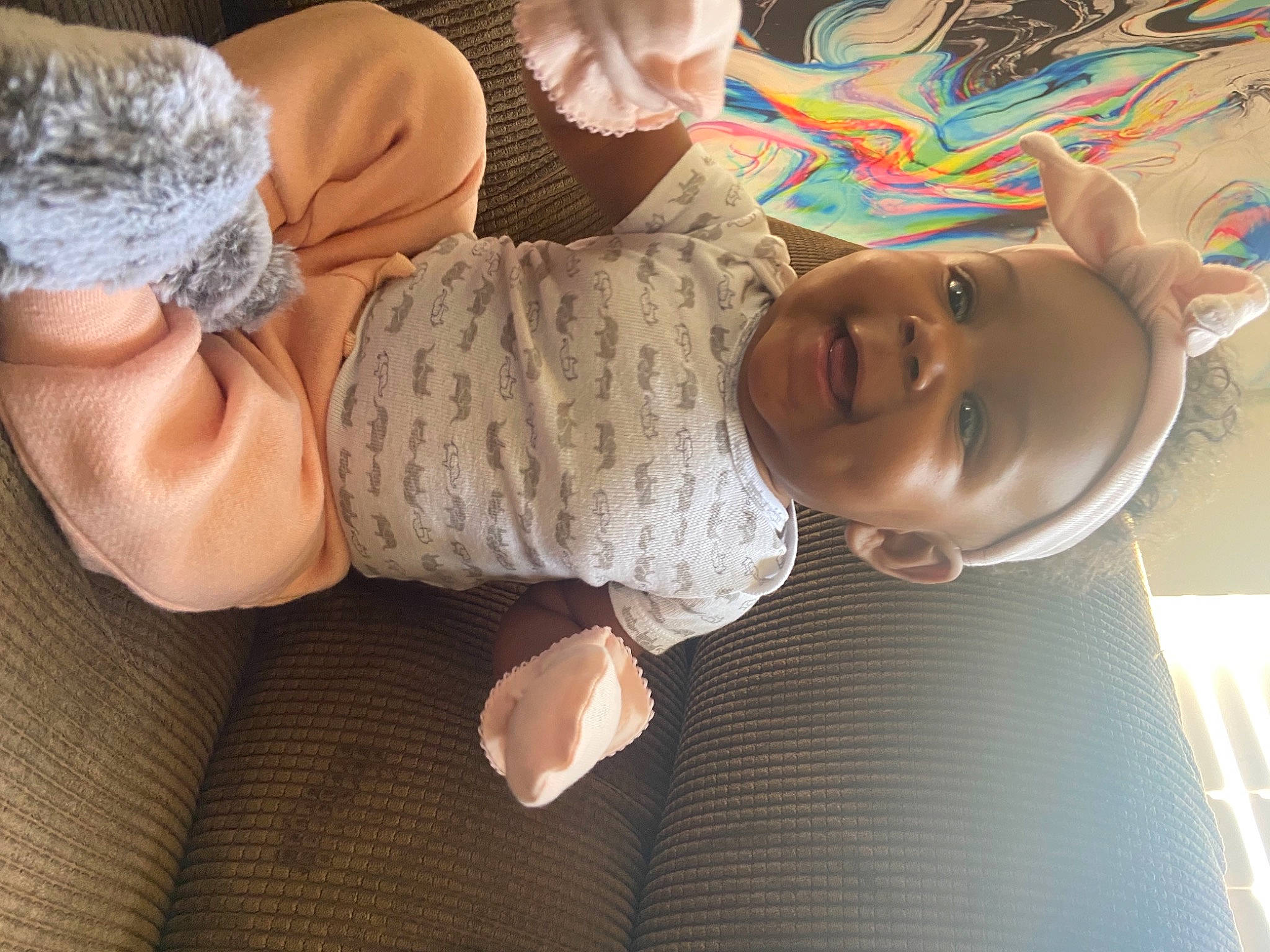 Janiya is registered to the contest to win money with this photo: baby, baby_toddler_clothing, comfort, elbow, finger, flooring, gesture, happy, headgear, human_body, human_leg, mouth, nail, person, product, sleeve, smile, thigh, thumb, toddler
