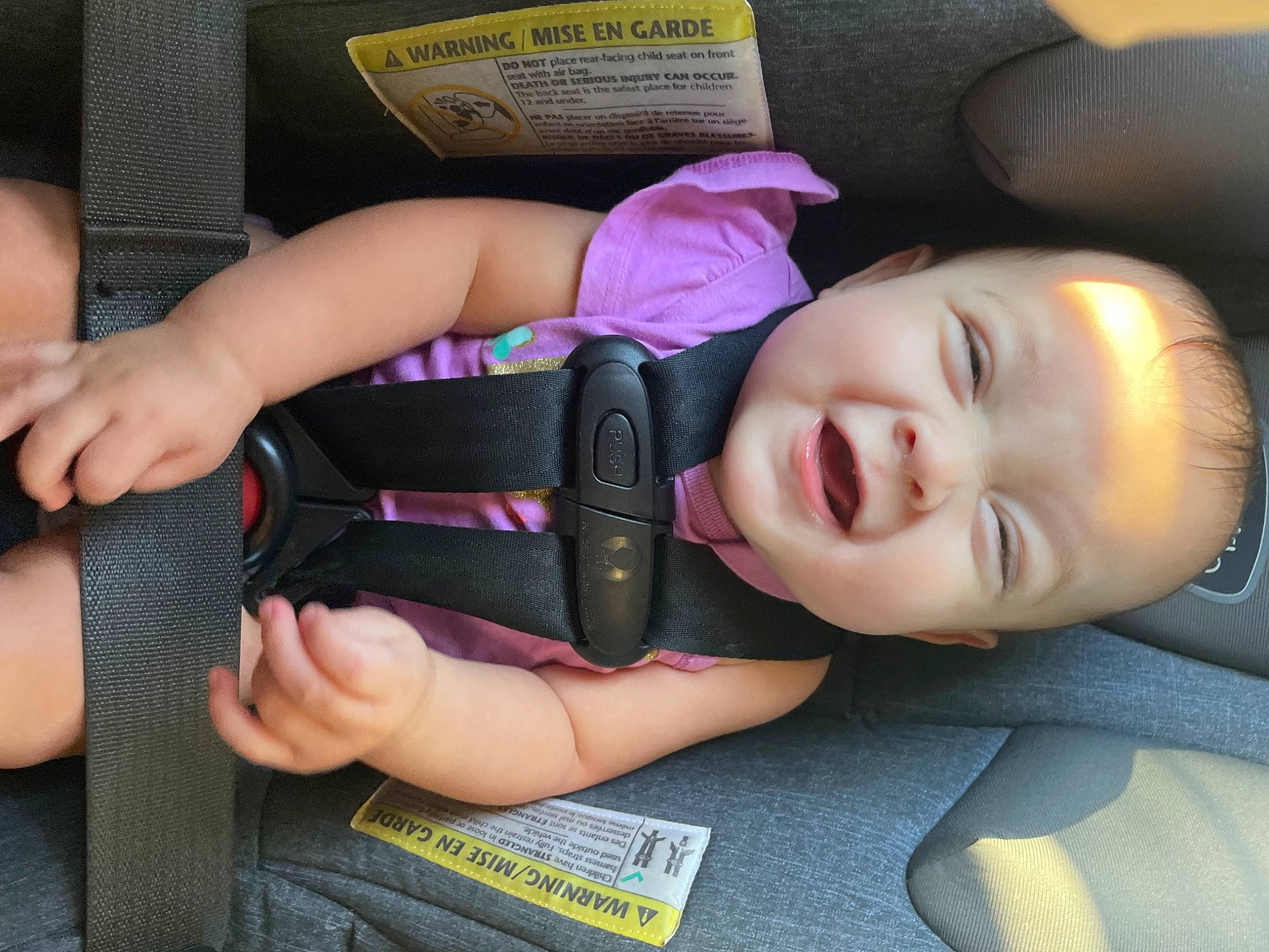Luna is registered to the contest to win money with this photo: baby, baby_toddler_clothing, car_seat, cheek, chin, comfort, eye, eyebrow, eyelash, facial_expression, finger, gesture, hairstyle, hand, lip, mouth, nose, person, skin, smile