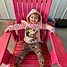 child, toddler, pink_chair, hoodie, minnie_mouse, leopard_print, leggings, boots, smile, happy, outdoor, wood, seat, clothing, person, casual, sitting, concrete, metal_wall, playful
