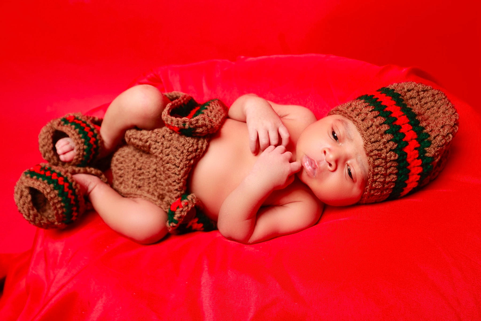 Kareem joined the competition — help win amazing prizes! baby, baby_sleeping, baby_toddler_clothing, child, comfort, eye, finger, flash_photography, headgear, headwear, human_body, lip, mammal, pattern, person, pink, room, sitting, skin, textile