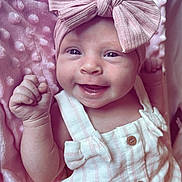 Isla-Rose is registered to the contest to win money with this photo: baby, smiling, infant, pink_bow, headband, blanket, soft_texture, clothing, cute, happy, portrait, closeup, skin, hand, buttoned_outfit, baby_girl, lying_down, baby_fashion, adorable, newborn