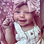 baby, smiling, infant, pink_bow, headband, blanket, soft_texture, clothing, cute, happy, portrait, closeup, skin, hand, buttoned_outfit, baby_girl, lying_down, baby_fashion, adorable, newborn