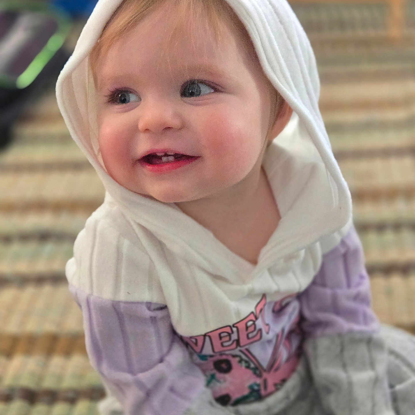 Gracelyn joined the competition — help win amazing prizes! baby, blond_hair, cheeks, child, clothing, cozy, cute, face, happy, hood, indoor, person, portrait, sitting, smile, sweater, teeth, toddler, warm, young_child