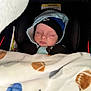 Isaiah joined the competition — help win amazing prizes! baby, infant, sleeping, car_seat, blanket, beanie, hat, hoodie, closed_eyes, newborn, cozy, nike_logo, warning_label, plush_blanket, winter_clothing, portrait, head_support, infant_carrier, soft_texture, peaceful