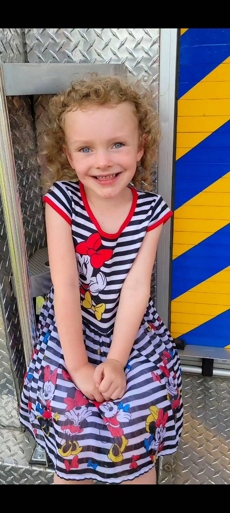 Lilly is registered to the contest to win money with this photo: blue, cool, dress, electric_blue, eye, face, facial_expression, fun, hairstyle, happy, joy, leisure, neck, pattern, person, shoulder, sleeve, smile, standing, street_fashion