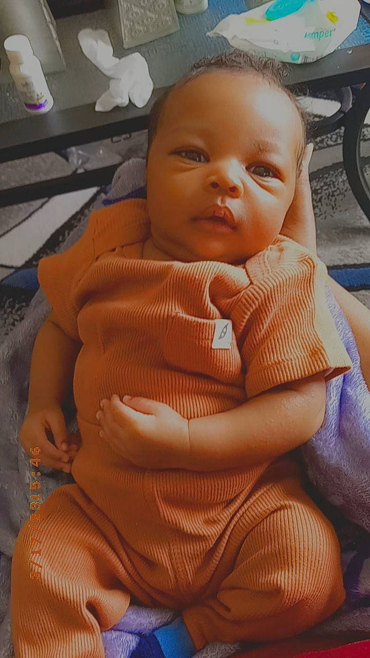 Jordan is registered to the contest to win money with this photo: baby, baby_safety, baby_toddler_clothing, bicycle_wheel, cheek, comfort, eyebrow, finger, hand, mouth, neck, nose, person, shoulder, skin, smile, textile, thumb, tire, toddler