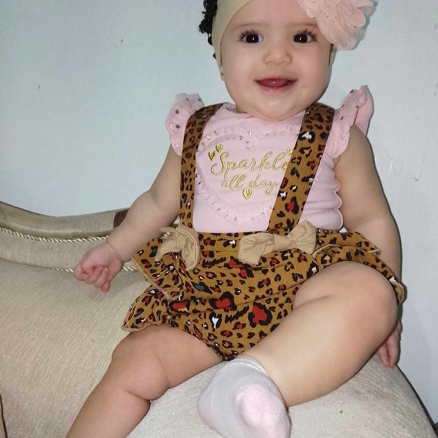 Ashlley joined the competition — help win amazing prizes! arm, baby, child, clothing, couch, cute, eyes, face, flower, girl, happy, headband, indoors, leopard_print, mouth, sitting, skin, smiling, sock, tongue