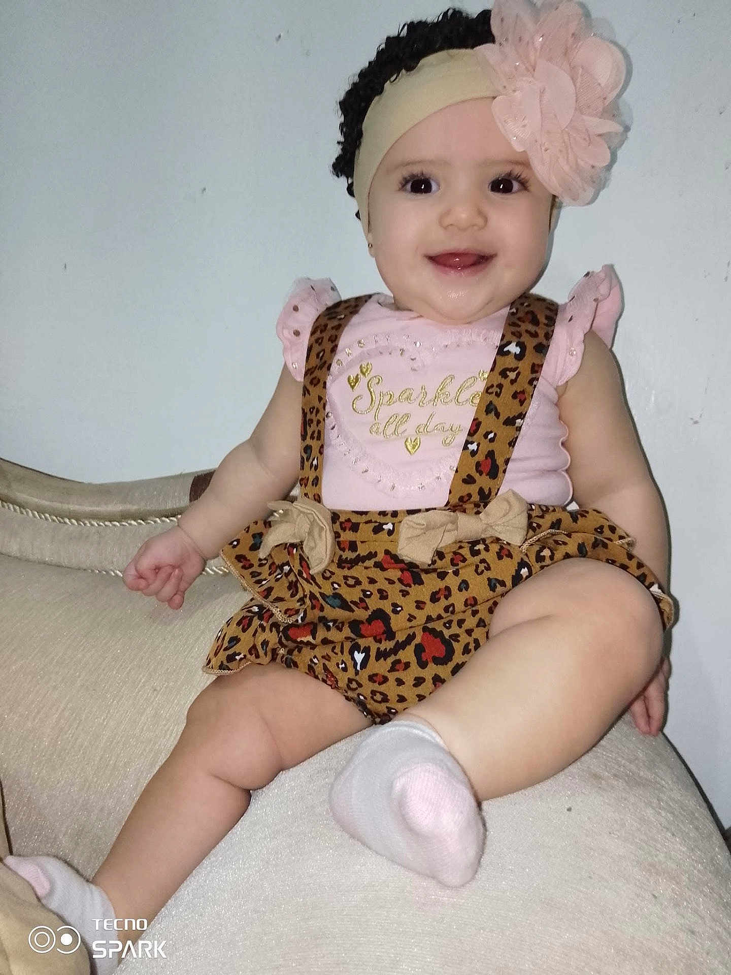 Ashlley joined the competition — help win amazing prizes! baby, child, smiling, girl, headband, flower, leopard_print, clothing, sitting, couch, indoors, cute, happy, sock, skin, face, eyes, mouth, tongue, arm