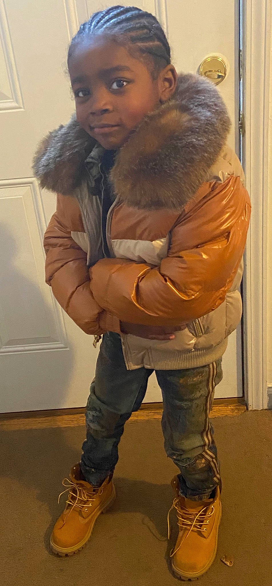 England is registered to the contest to win money with this photo: animal_product, beard, cool, eyewear, fur_clothing, gesture, glove, jacket, jeans, leg, natural_material, outerwear, parka, person, shoe, shoulder, sleeve, standing, street_fashion, thigh