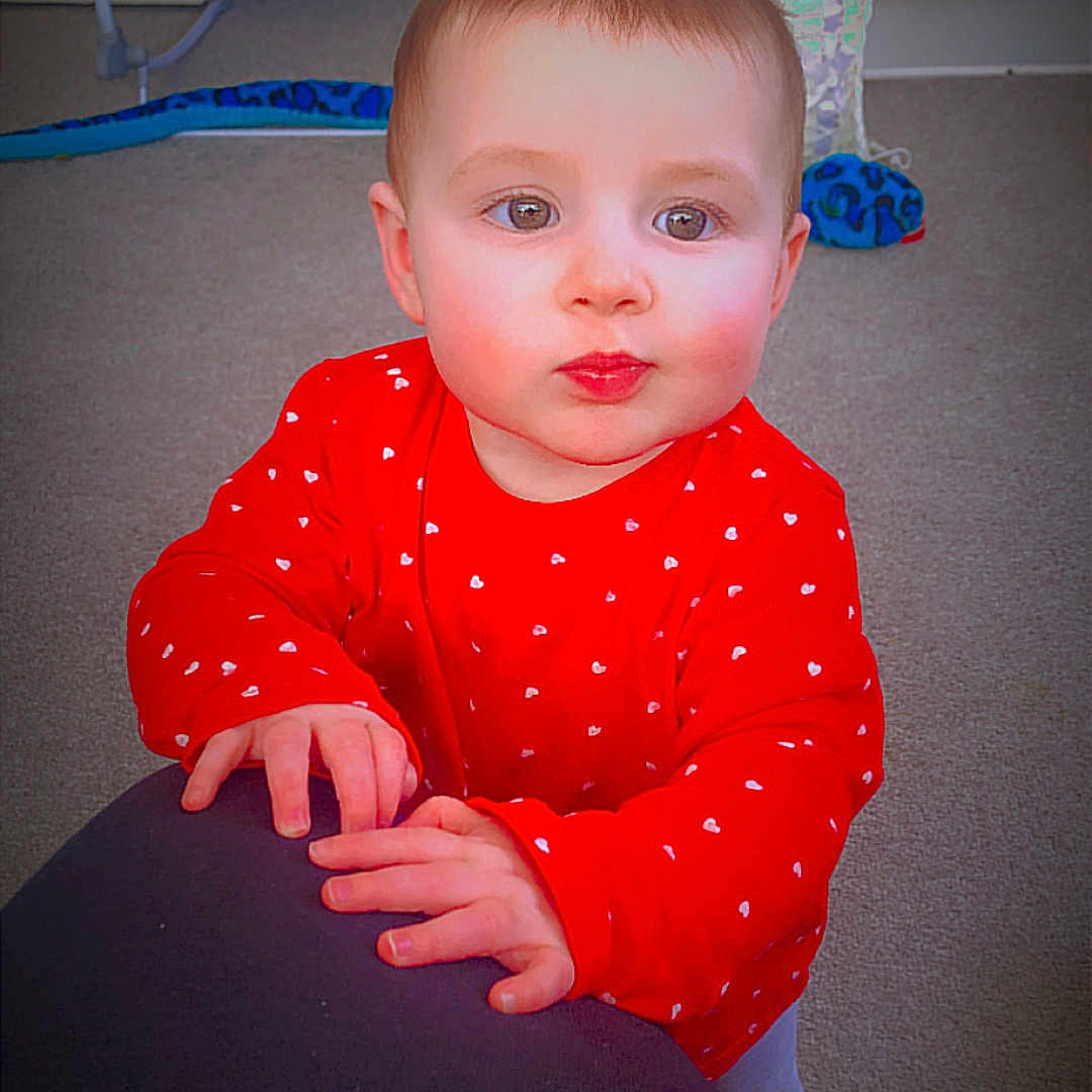 Nova joined the competition — help win amazing prizes! baby, baby_swing, carpet, child, couch, curious_expression, cute, face, furniture, hands, hearts_pattern, home, indoor, person, play_area, portrait, red_shirt, toddler, toy_snake, young_child