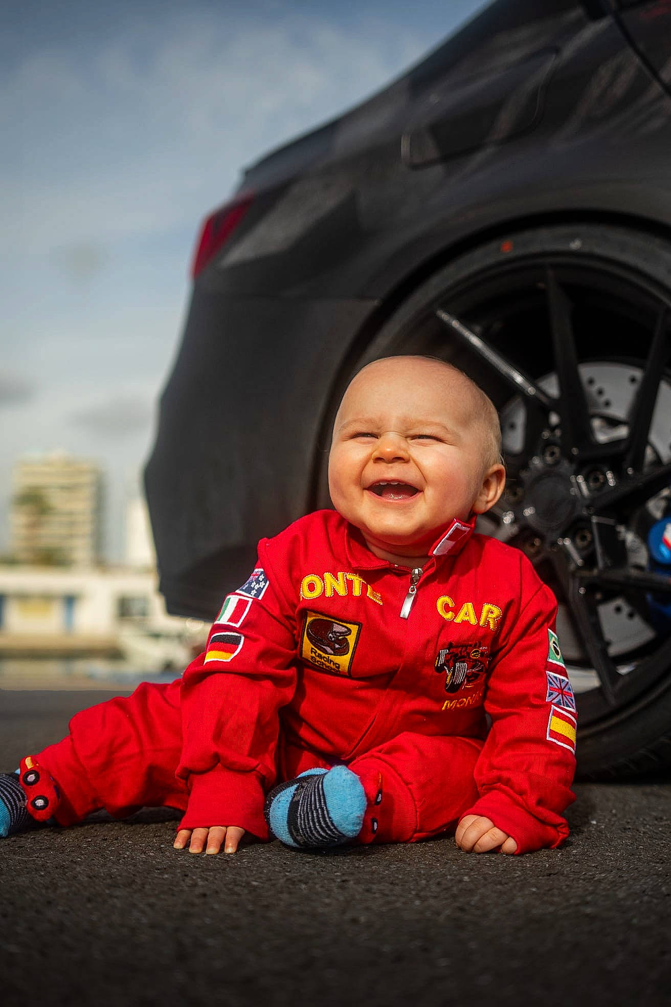 Tadeo participe au concours pour gagner de l'argent avec cette photo : automotive_tire, automotive_wheel_system, baby, baby_toddler_clothing, flash_photography, flooring, fun, grass, happy, jacket, joy, person, rim, rolling, sitting, sky, sleeve, t_shirt, tire, toddler