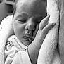 baby, newborn, sleeping, black_and_white, close_up, infant, blanket, cuddle, peaceful, soft_texture, face, hand, cute, portrait, clothing, rest, cozy, young_child, toddler, quiet