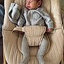newborn, baby, sleeping, knitted_outfit, baby_rocker, beige, cozy, infant, child, indoor, peaceful, soft_lighting, cushion, wooden_frame, baby_clothing, toddler, cute, resting, portrait, one_person