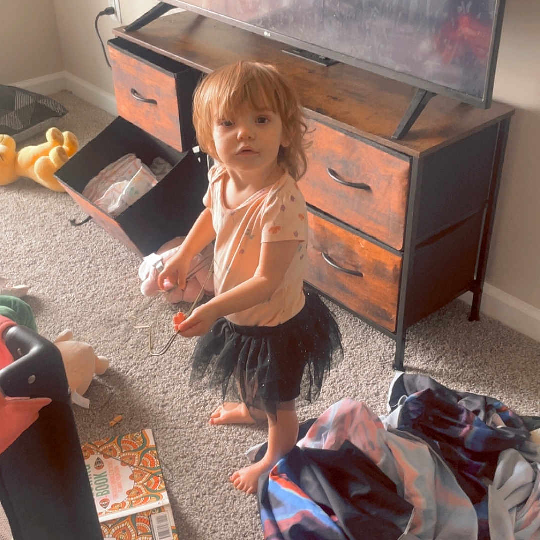 Lily joined the competition — help win amazing prizes! baby, bag, cabinet, child, clothing, drawer, dress, electronics, face, female, furniture, girl, hardwood, head, indoors, person, photography, portrait, sitting, wood