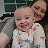 Rylee is registered to the contest to win money with this photo: baby, child, adult, smiling, happy, portrait, close_up, cuddling, indoor, home, family, infant, onesie, pajamas, colorful_clothing, wall_art, furniture, sitting, selfie, face