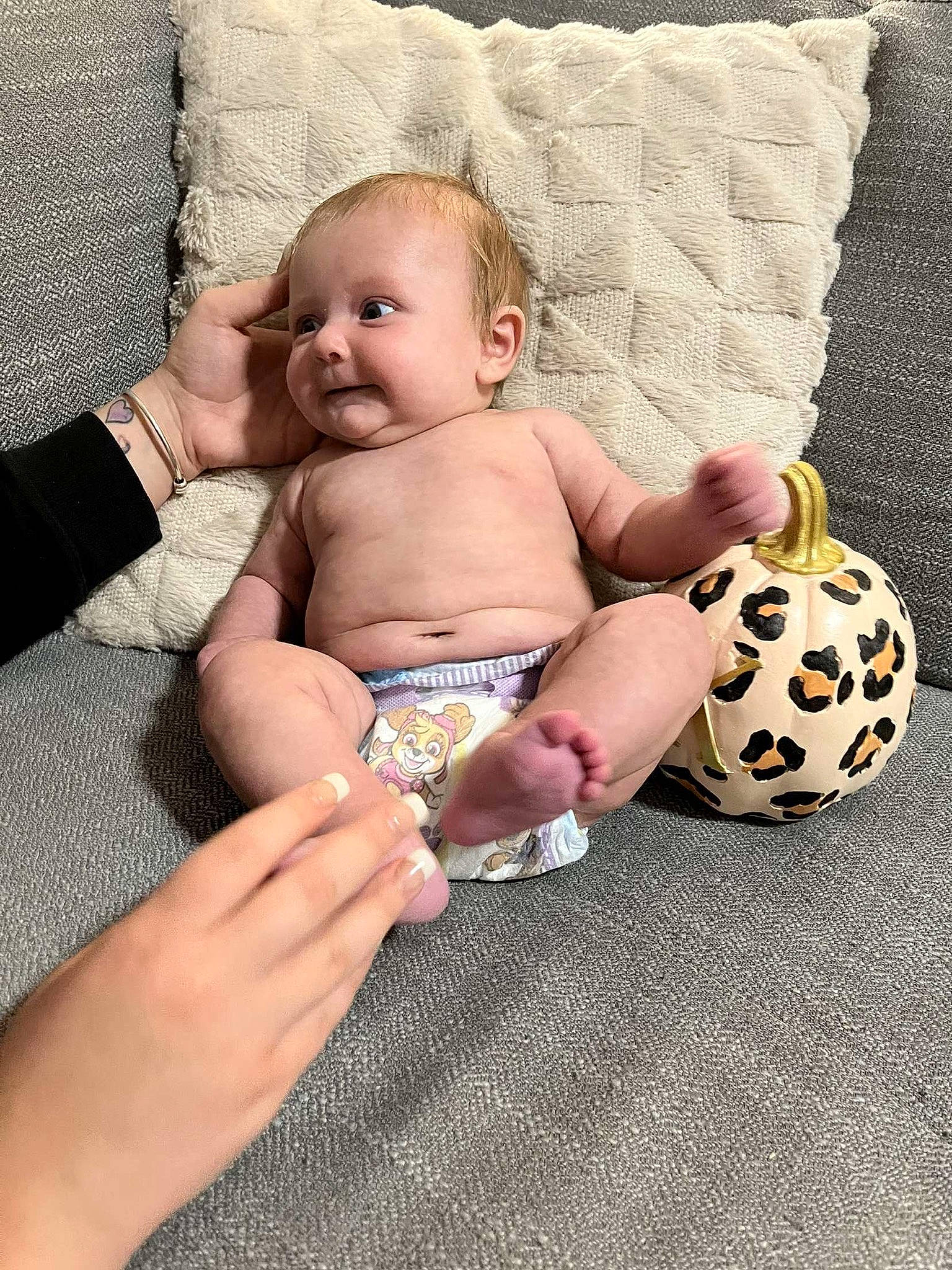 Kylie is registered to the contest to win money with this photo: abdomen, baby, baby_products, baby_sleeping, baby_toddler_clothing, child, comfort, couch, finger, foot, football, human_leg, linens, nail, person, room, sitting, thigh, thumb, toddler