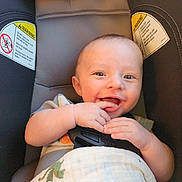 Max joined the competition — help win amazing prizes! baby, smiling, car_seat, child, infant, blanket, happy, face, hands, cute, seatbelt, indoors, person, young_child, dinosaur_print, cozy, portrait, playful, skin, light