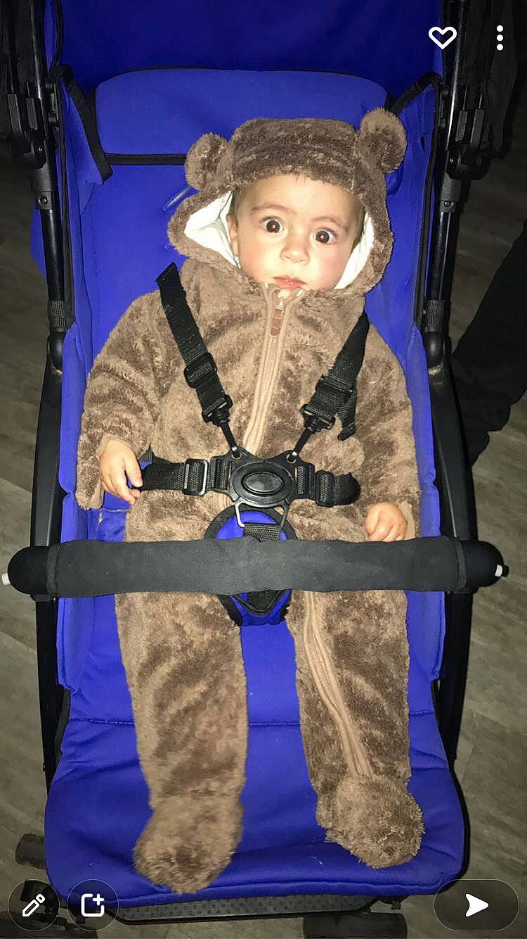 Mayron a rejoint le concours — aidez-le/la à gagner de superbes lots ! baby_carriage, baby_products, belt, chair, child, costume, electric_blue, event, fashion_accessory, fun, fur, glove, headgear, person, personal_protective_equipment, room, sitting, strap, toddler, uniform