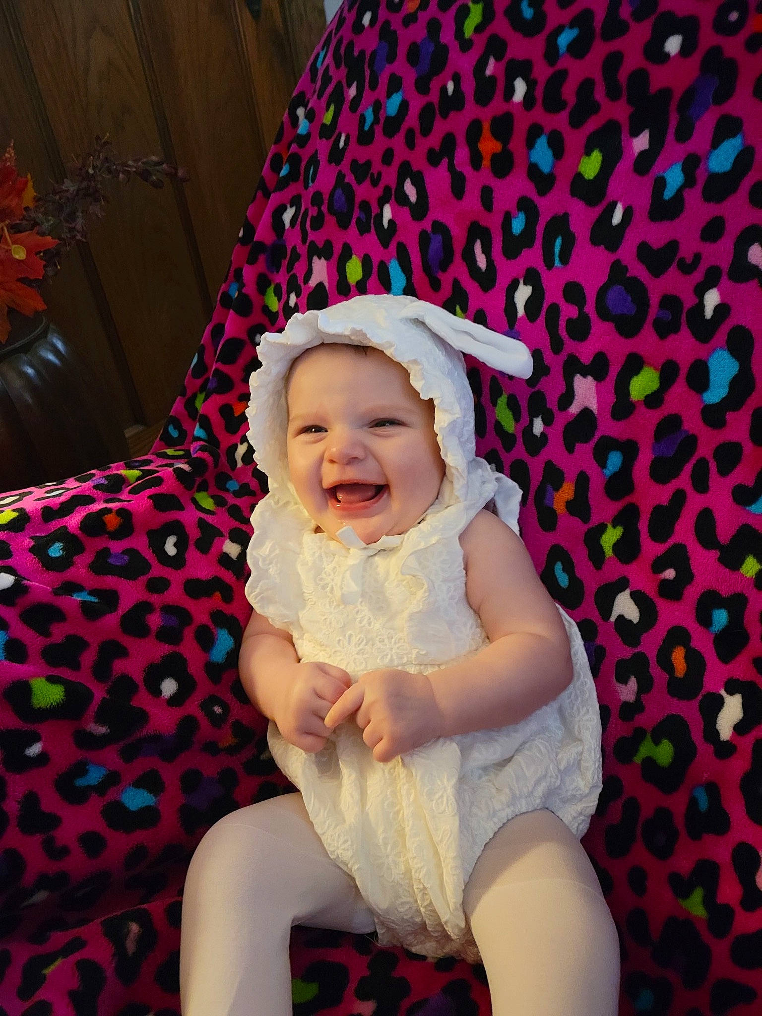 Alivia is registered to the contest to win money with this photo: baby, baby_toddler_clothing, cap, child, couch, fun, happy, hat, headgear, headwear, magenta, pattern, person, pink, purple, sitting, sleeve, smile, sun_hat, thigh