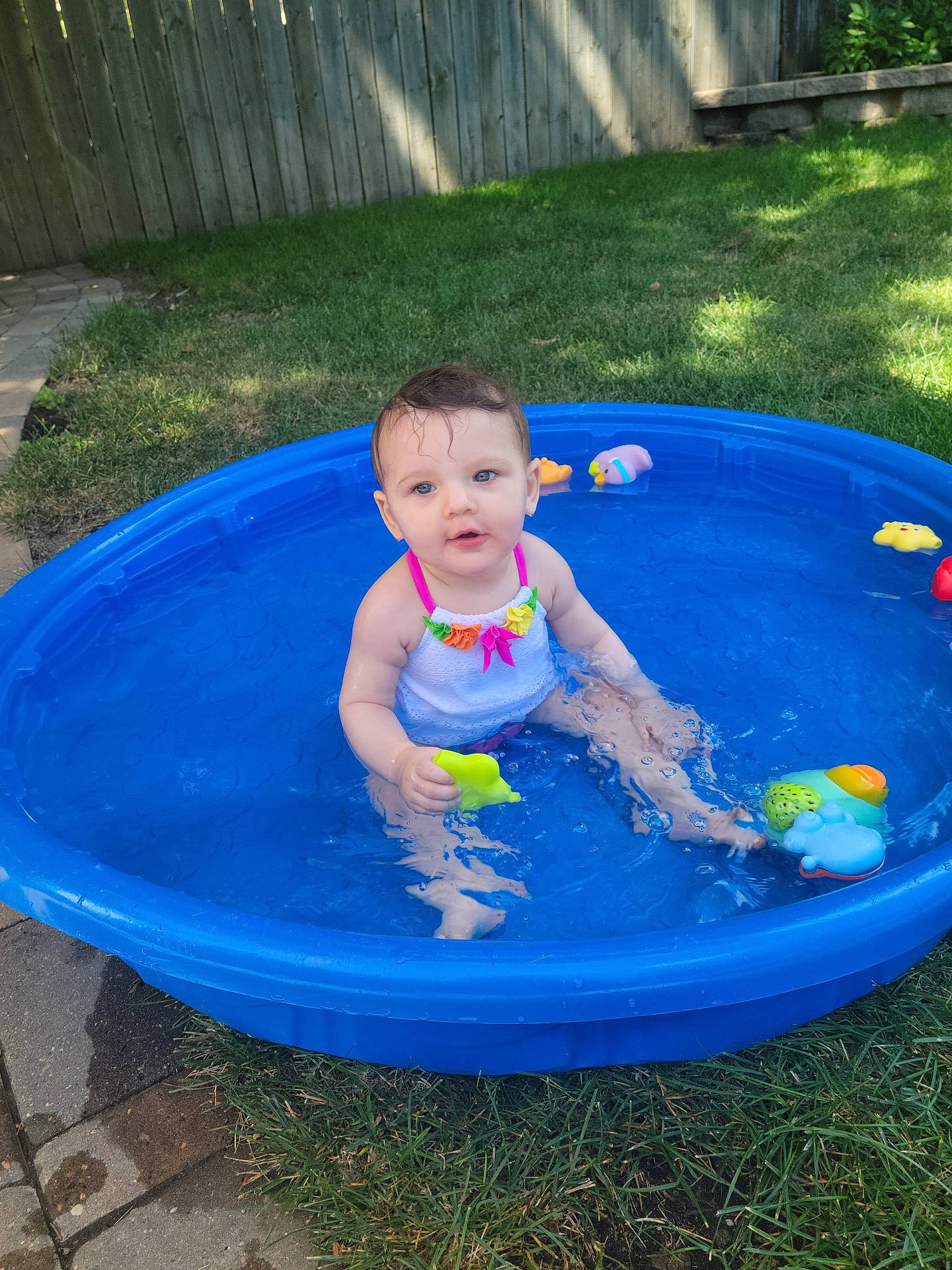 Alivia is registered to the contest to win money with this photo: aqua, baby, baby_bathing, baby_toddler_clothing, bathing, blue, child, circle, composite_material, fun, games, grass, inflatable, leisure, nonbuilding_structure, person, play, recreation, toddler, water
