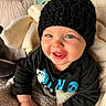 baby, black_hat, blanket, blue_eyes, child, clothing, cozy, cute, face, hand, happy, indoor, infant, knitwear, pacifier, portrait, smiling, soft_texture, warm_lighting, young_child