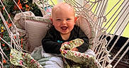 Miles joined the competition — help win amazing prizes! baby, smiling, hammock, blanket, cushion, indoor, child, happy, face, cozy, quilt, greenery, window, pillow, sock, seated, fabric, home, portrait, cute
