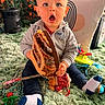 baby, casual, child, clothing, cushion, doll, expression, floor, furniture, heater, home, indoor, knitted_object, person, pillow, plant, rug, socks, surprise, toy