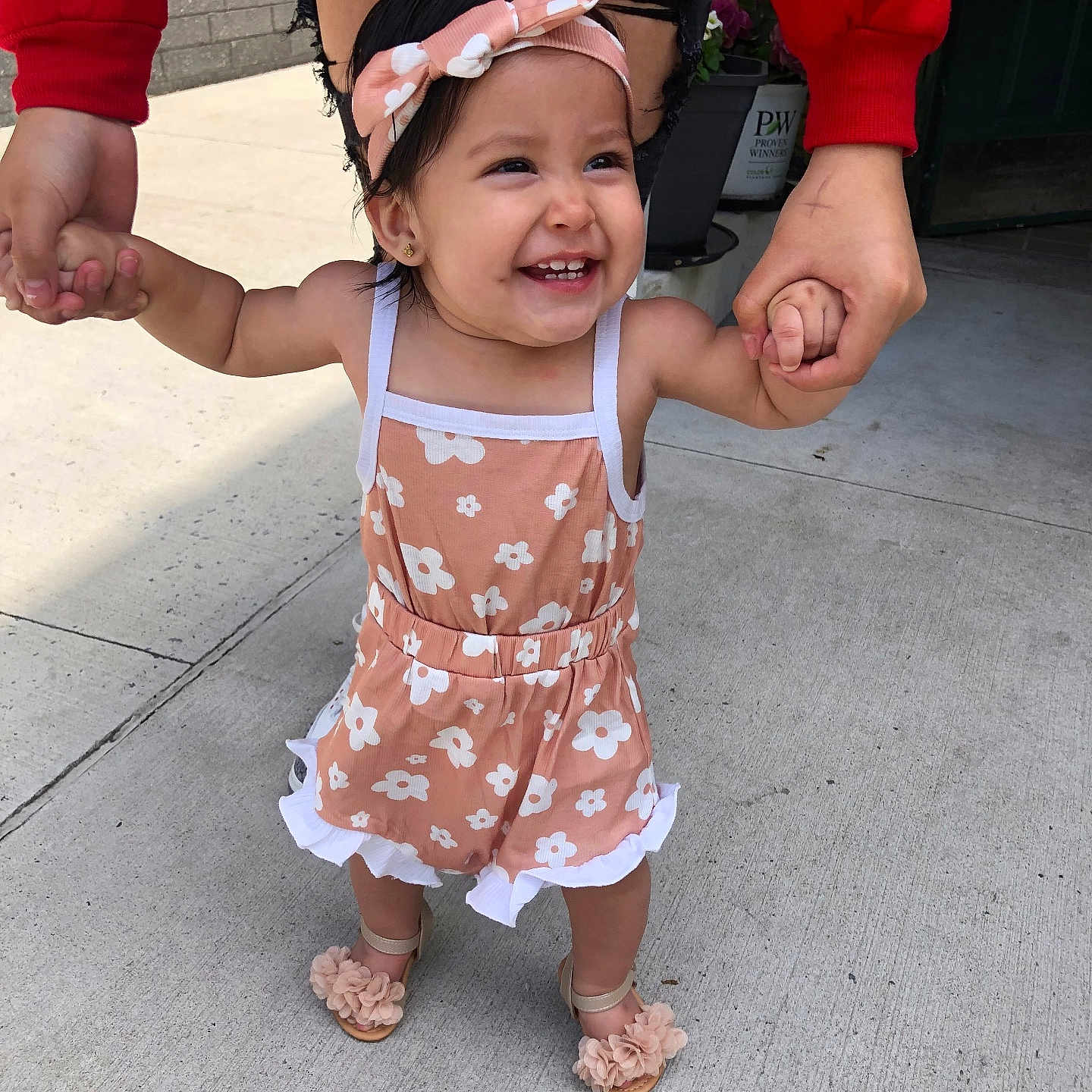 Genevieve is registered to the contest to win money with this photo: accessories, baby, city, clothing, dress, face, footwear, happy, head, jewelry, pants, person, photography, portrait, road, sandal, shorts, skirt, street, urban