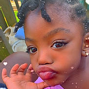 Amarah is registered to the contest to win money with this photo: child, face, hand, braided_hair, outdoor, pink_shirt, cute, portrait, expression, close_up, playful, skin, eyes, lips, earring, background_blur, heart_effects, young, person, casual
