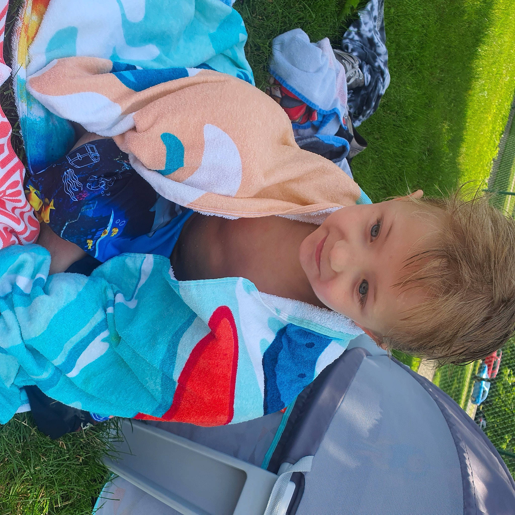 Cameryn is registered to the contest to win money with this photo: azure, baby, baby_products, baby_toddler_clothing, blue, child, electric_blue, event, fun, grass, happy, hat, lap, leisure, person, recreation, sitting, smile, toddler, tree