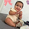 baby, bed, bracelet, child, dress, face, fashion, happy, home, indoors, infant, person, photography, pink_bow, portrait, purse, shoes, sitting, smiling, wall