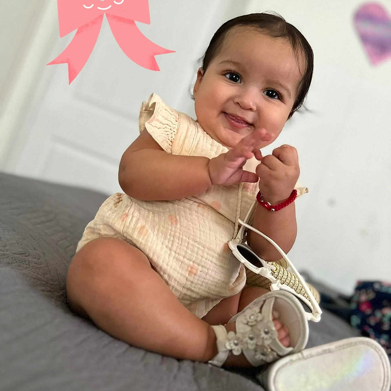 Adrially joined the competition — help win amazing prizes! baby, bed, bracelet, child, dress, face, fashion, happy, home, indoors, infant, person, photography, pink_bow, portrait, purse, shoes, sitting, smiling, wall